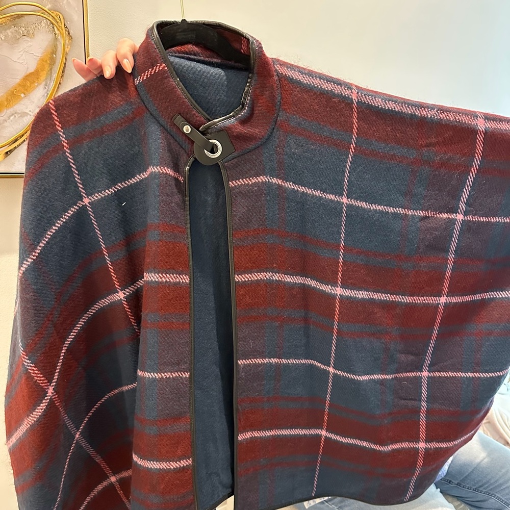 Acrylic cape with faux leather trim. One size fits all, up to x-large. New/Tags.